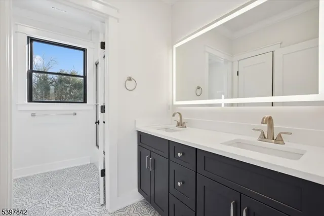 a bathroom with a granite countertop sink toilet and a shower