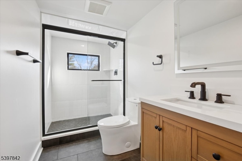 32 Felch Road Florham Park, NJ 07932 - Photo 33 of 45 a bathroom with a granite countertop sink toilet and a shower