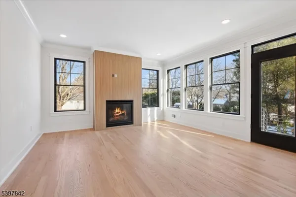 a large kitchen with kitchen island a large counter top space a sink stainless steel appliances and cabinets