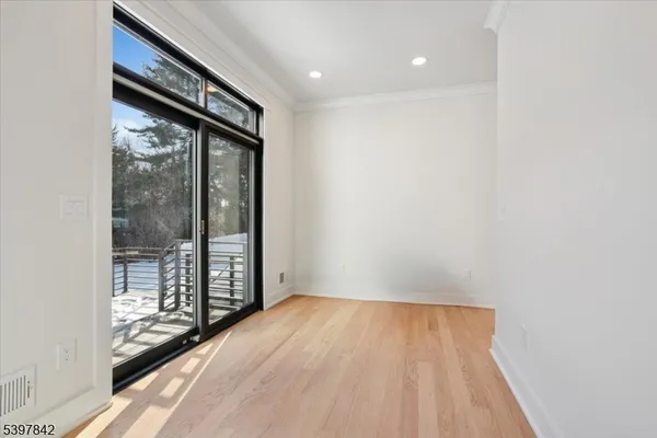 a living room with storage and a rug