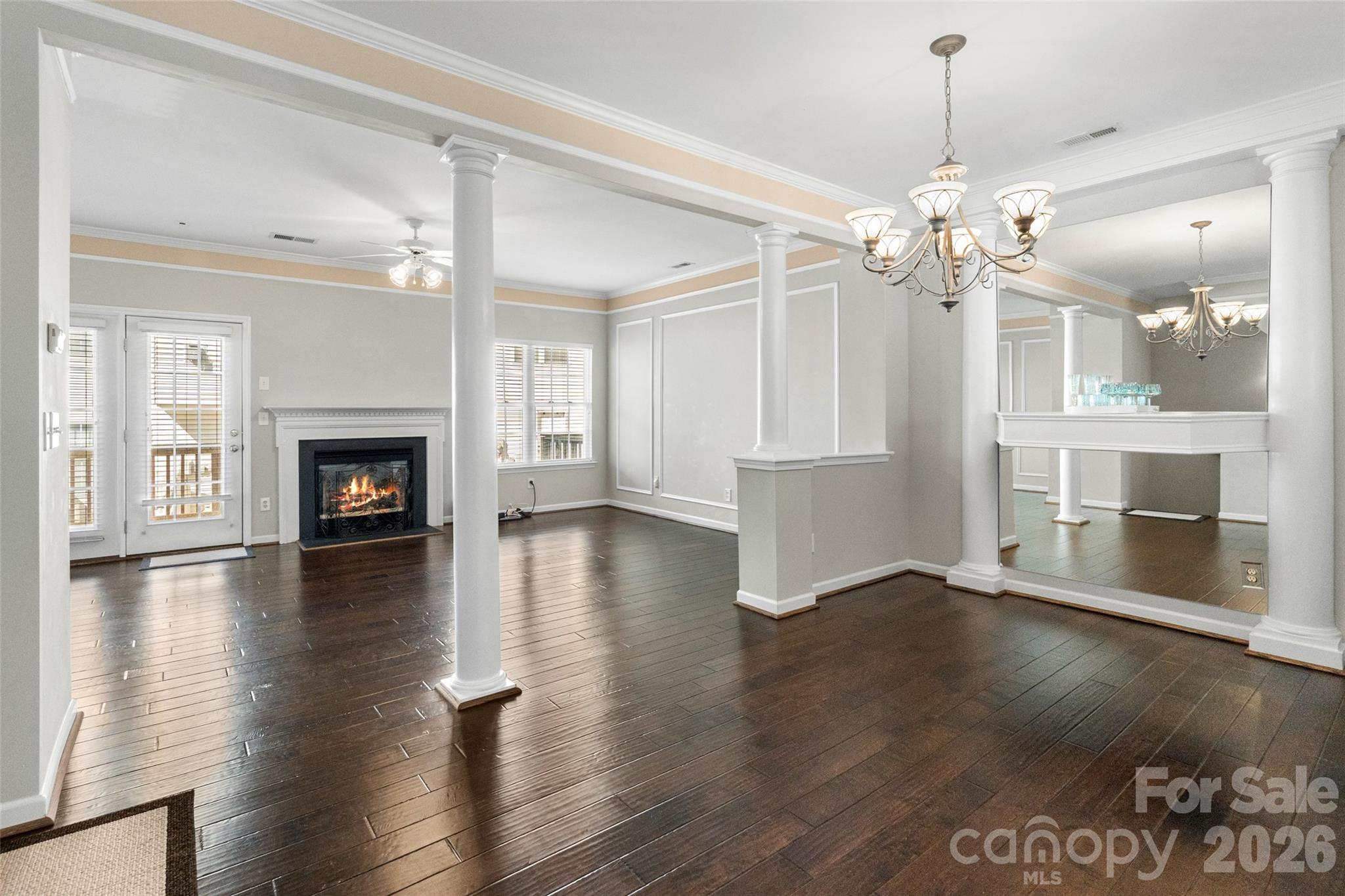 104 Rock Ridge Lane Mount Holly, NC 28120 - Photo 15 of 48 an empty room with wooden floor fireplace and windows
