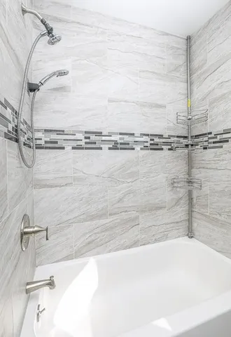 a bathroom with a bathtub and shower