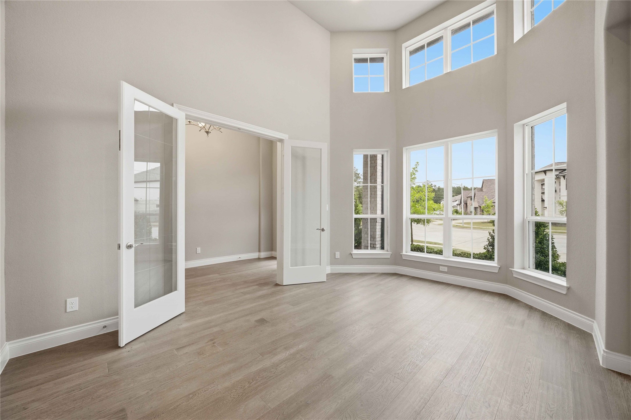 17564 Watercolor Way Conroe, TX 77302 - Photo 7 of 42 Glass doors invite you into the spacious and bright home office lined with a row of windows offering abundant natural light