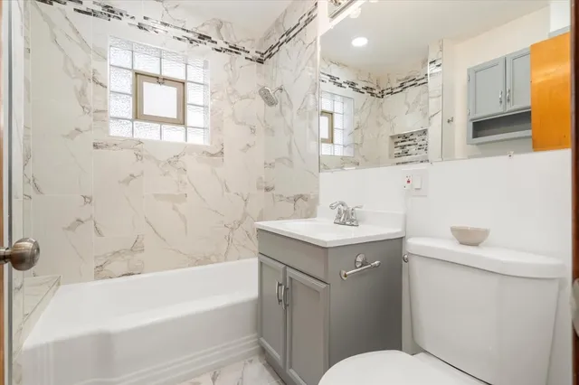 an empty room with wooden floor cabinet and windows