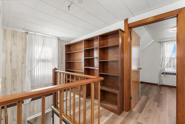 a view of an empty room and wooden floor