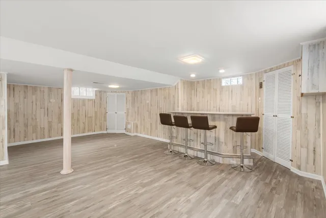 a kitchen with cabinets wooden floor and stainless steel appliances