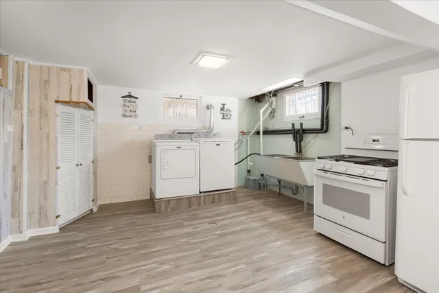 a view of a kitchen with a sink and a refrigerator