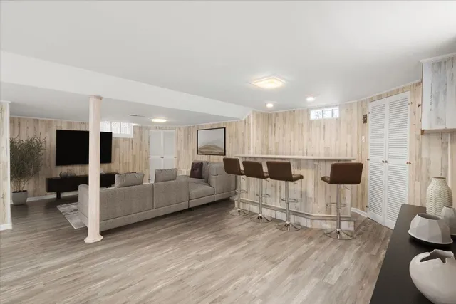 a living room with furniture a large window and a table