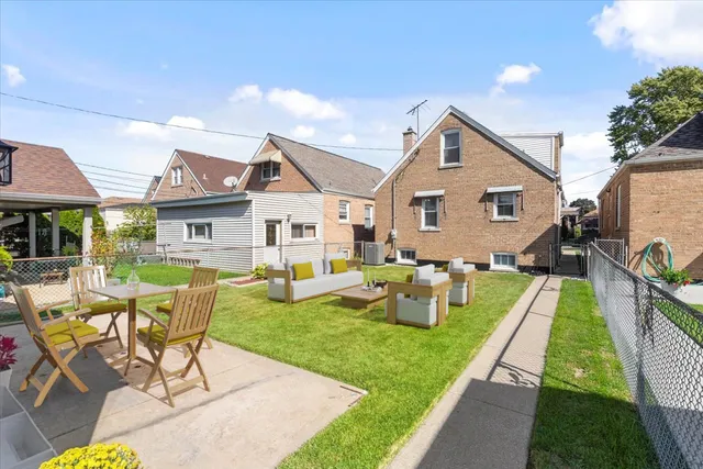 a front view of house with yard and outdoor seating