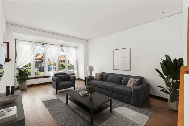 a living room with furniture a rug and a large window