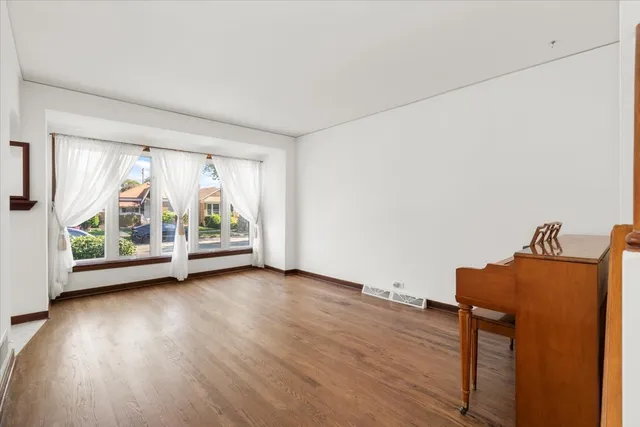 a view of room with window and wooden floor