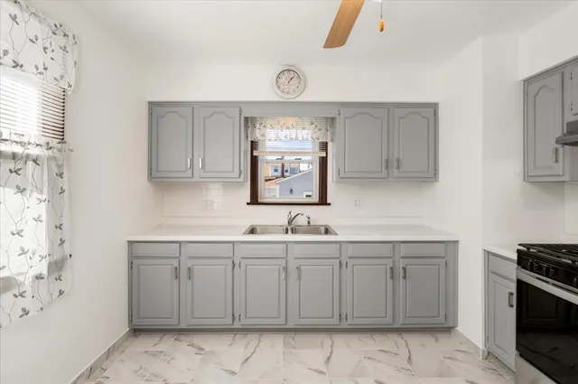 a kitchen with a sink cabinets and window