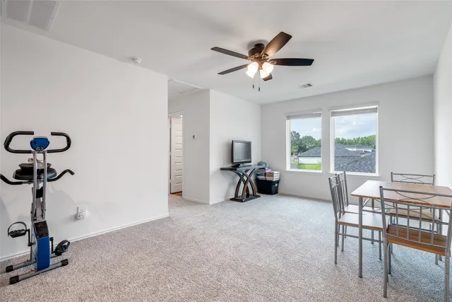 a view of a livingroom with furniture and a ceiling fan