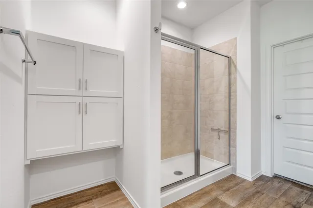 a bathroom with a glass shower door