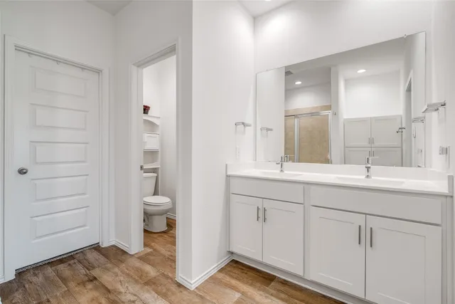 a bathroom with a toilet a sink and mirror