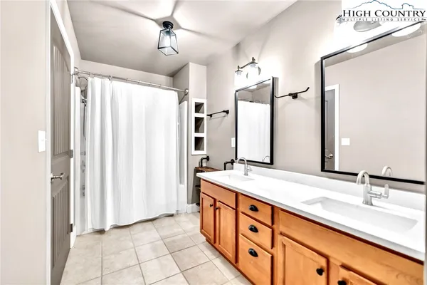 a spacious bathroom with a double vanity sink and a mirror
