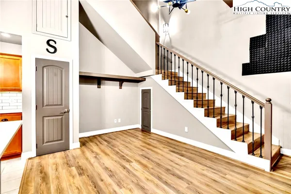 a view of entryway and hall with wooden floor