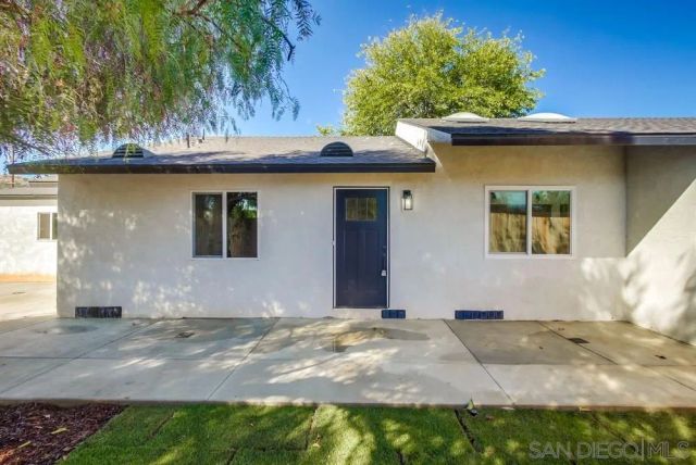 a living room with furniture a large window and a clock
