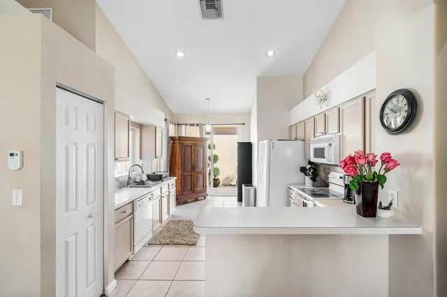 a view of living room filled with furniture and flower vase