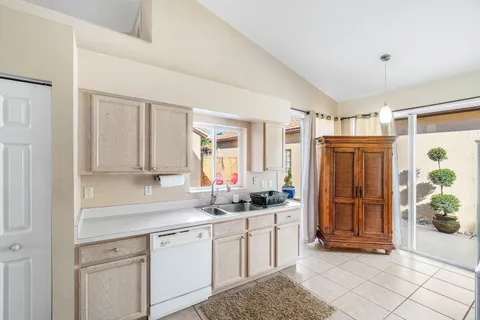 a kitchen with stainless steel appliances granite countertop a refrigerator sink and cabinets