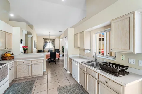 a kitchen that has a lot of cabinets in it and a window