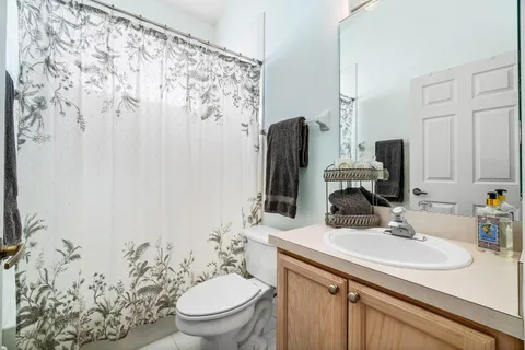a bathroom with a sink toilet and mirror