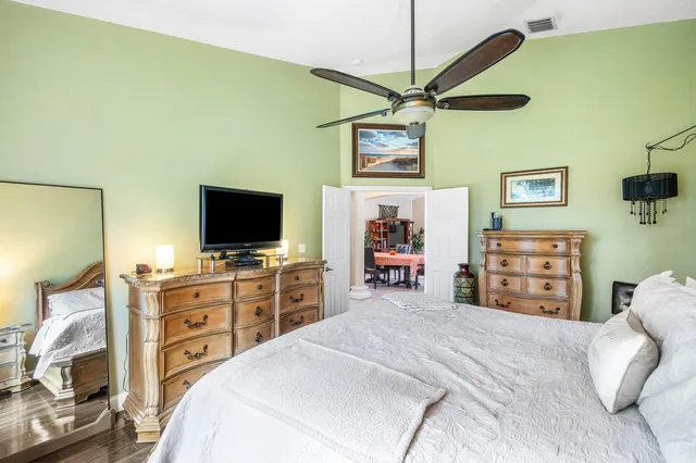 a bedroom with a bed and a flat screen tv