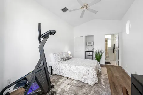 a bedroom with a bed window and a mirror