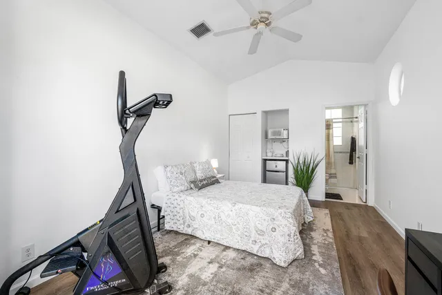 a bedroom with a bed window and a mirror