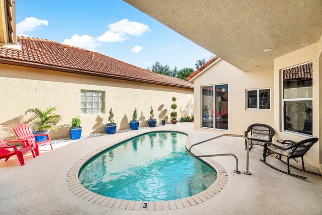 a view of a swimming pool with outdoor seating