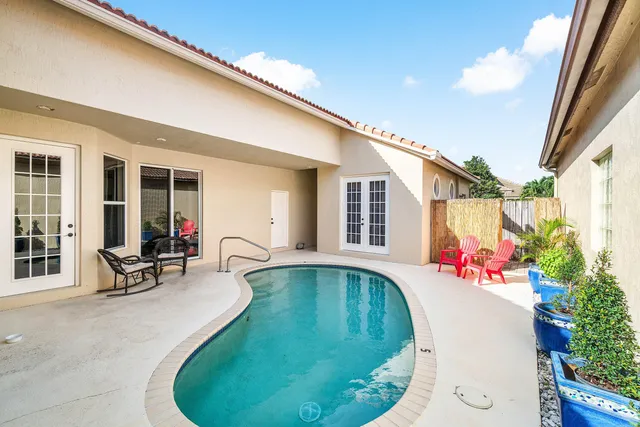 a swimming pool with outdoor seating
