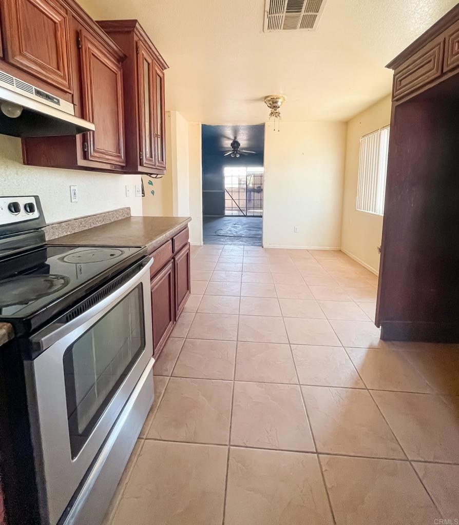 531 Lee Road Imperial, CA 92251 - Photo 11 of 18 a kitchen with granite countertop a stove a sink and a refrigerator