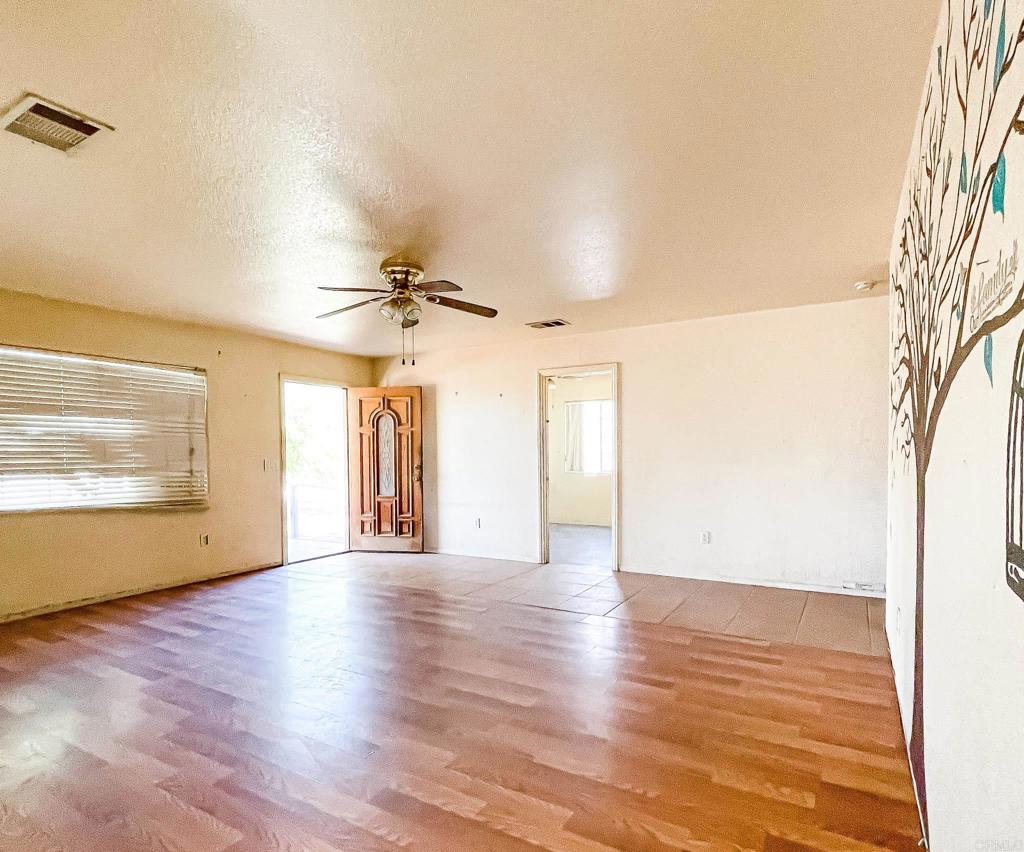 531 Lee Road Imperial, CA 92251 - Photo 8 of 18 a view of an empty room with wooden floor and a window