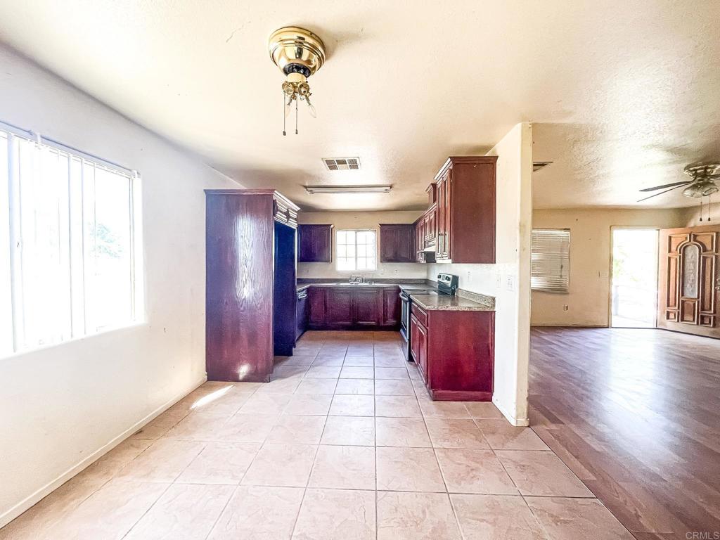 531 Lee Road Imperial, CA 92251 - Photo 9 of 18 a large kitchen with stainless steel appliances granite countertop a stove and a refrigerator