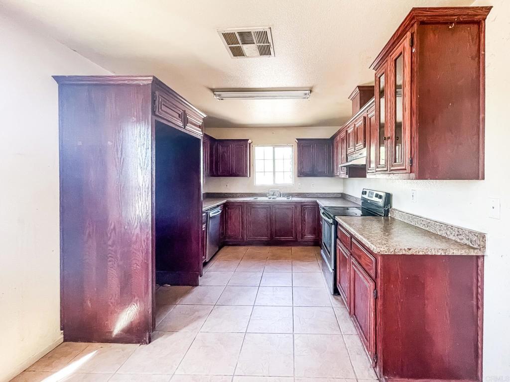 531 Lee Road Imperial, CA 92251 - Photo 10 of 18 a kitchen with stainless steel appliances granite countertop a sink and cabinets
