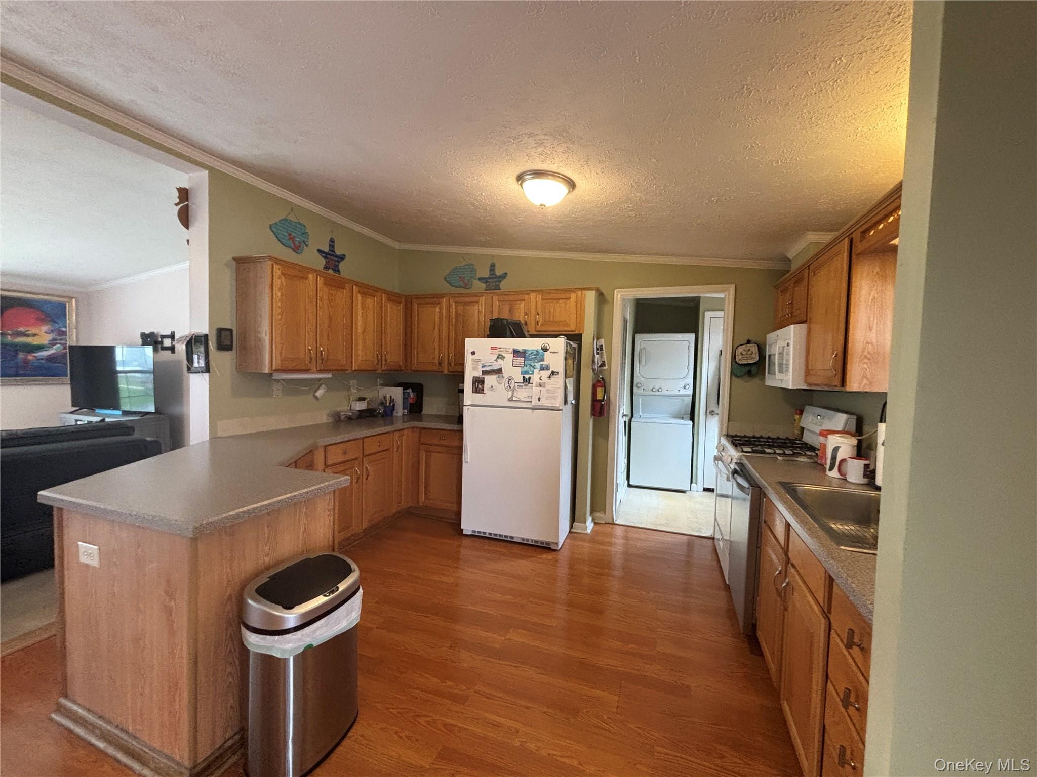 1661 Old Country Road, Unit 417 Riverhead, NY 11901 - Photo 11 of 20 a kitchen with a refrigerator a stove top oven a sink and dishwasher