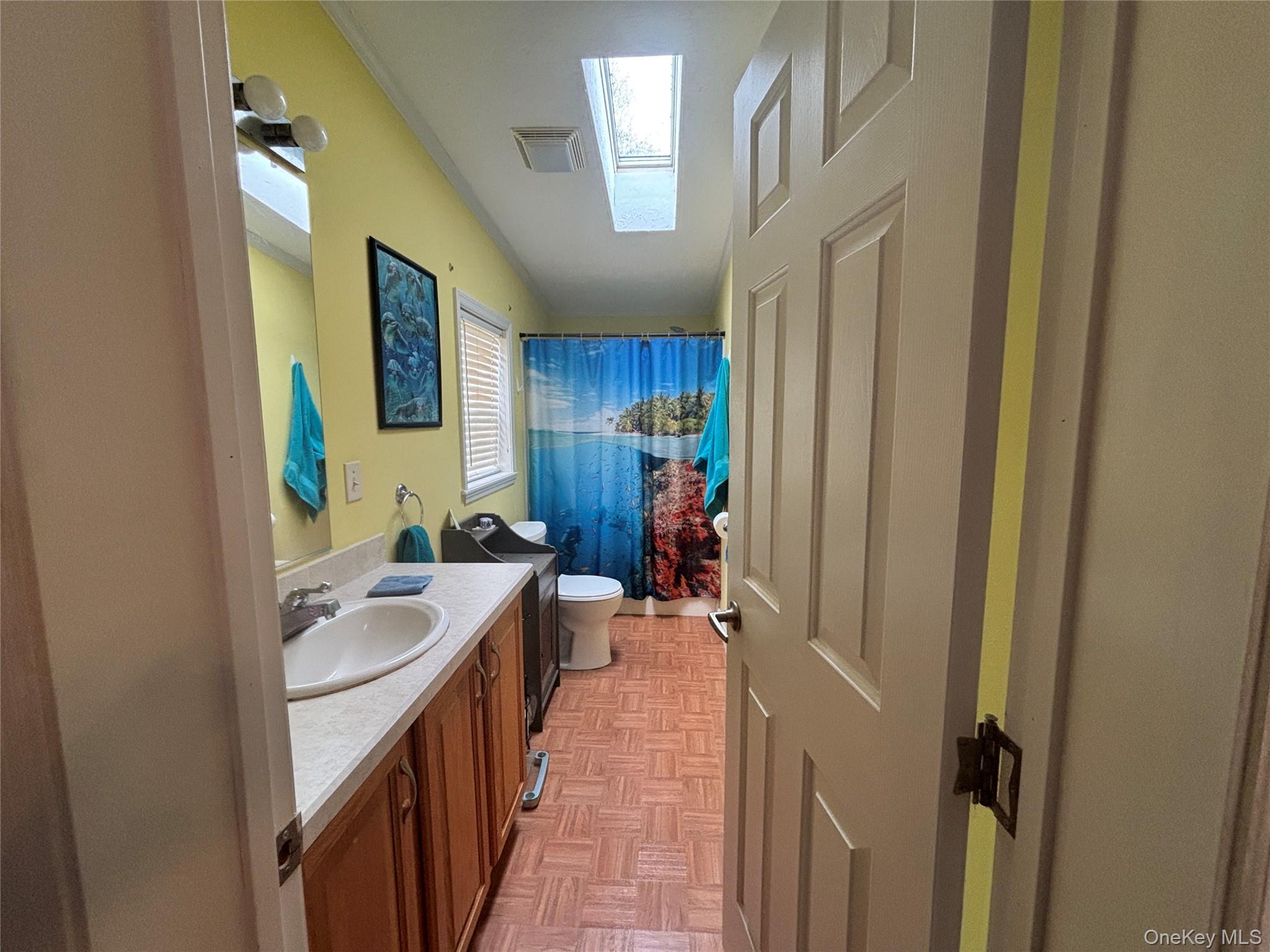 1661 Old Country Road, Unit 417 Riverhead, NY 11901 - Photo 14 of 20 a hallway with sink and wooden cabinets