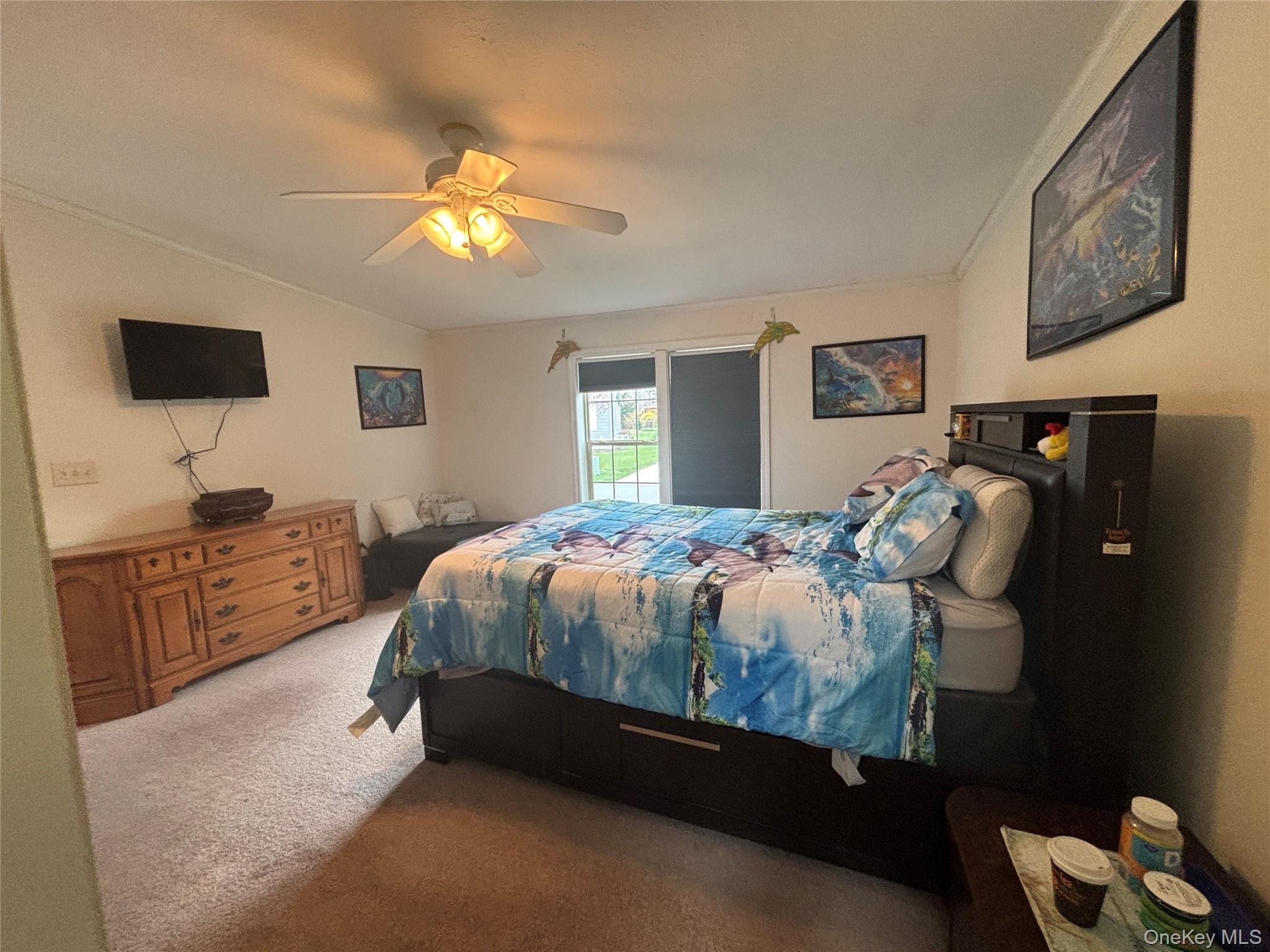 1661 Old Country Road, Unit 417 Riverhead, NY 11901 - Photo 16 of 20 a bedroom with bed cabinet and window