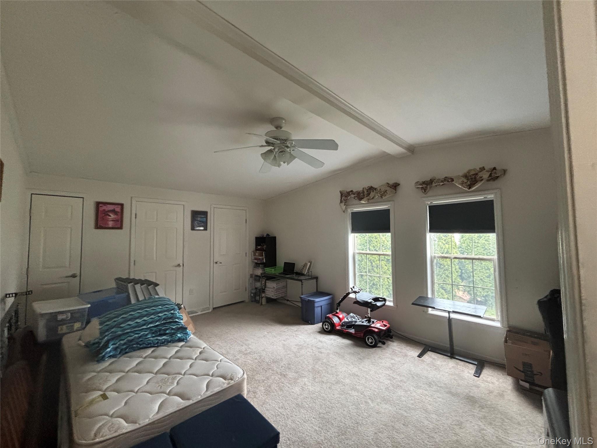 1661 Old Country Road, Unit 417 Riverhead, NY 11901 - Photo 17 of 20 a bedroom with furniture and a large window