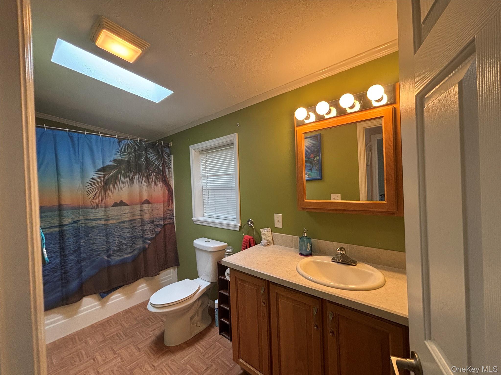 1661 Old Country Road, Unit 417 Riverhead, NY 11901 - Photo 20 of 20 a bathroom with a sink toilet and shower