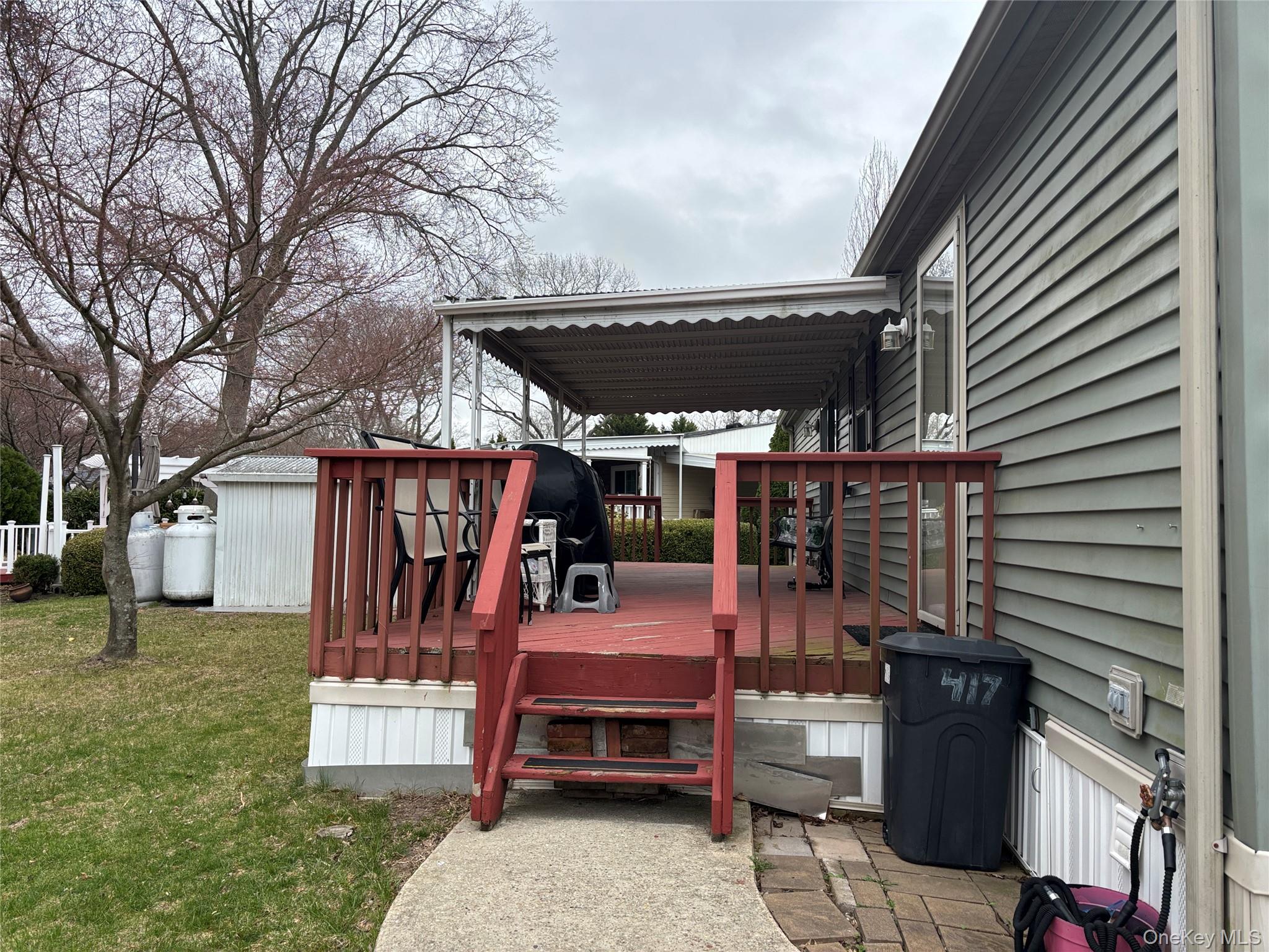 1661 Old Country Road, Unit 417 Riverhead, NY 11901 - Photo 4 of 20 a view of a patio with a table and chairs