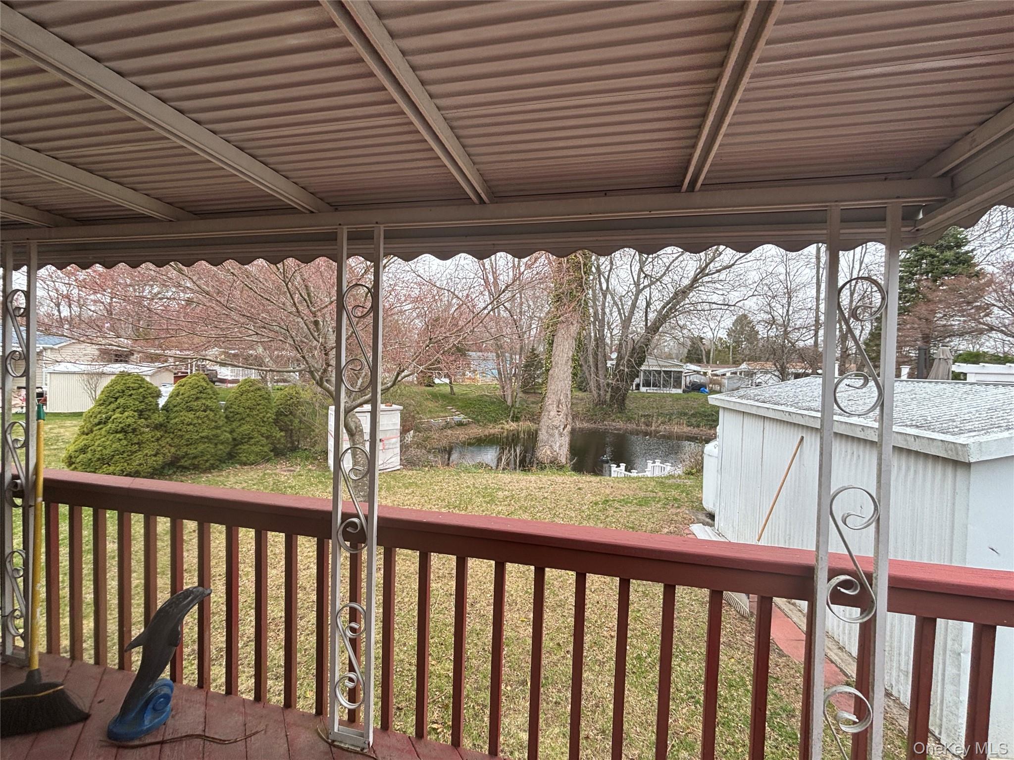 1661 Old Country Road, Unit 417 Riverhead, NY 11901 - Photo 6 of 20 a view of a porch with wooden floor