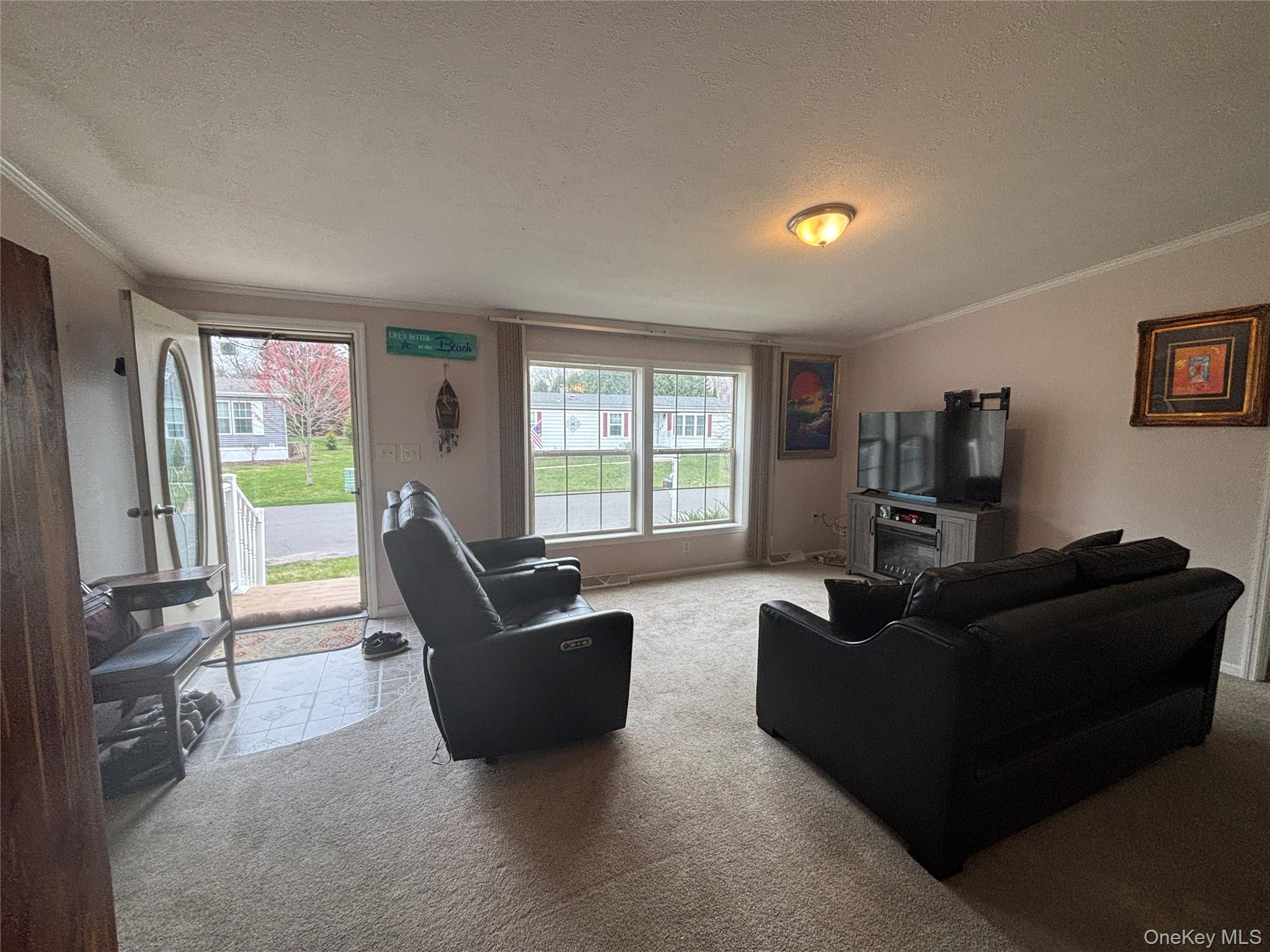 1661 Old Country Road, Unit 417 Riverhead, NY 11901 - Photo 8 of 20 a living room with furniture and a window