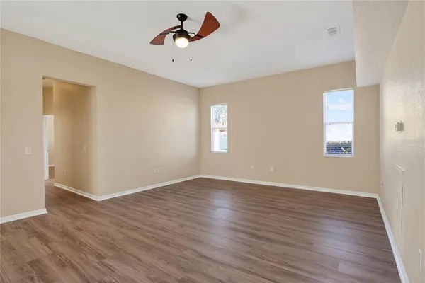 wooden floor in an empty room with a window