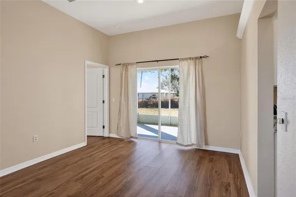 a view of a room with wooden floor
