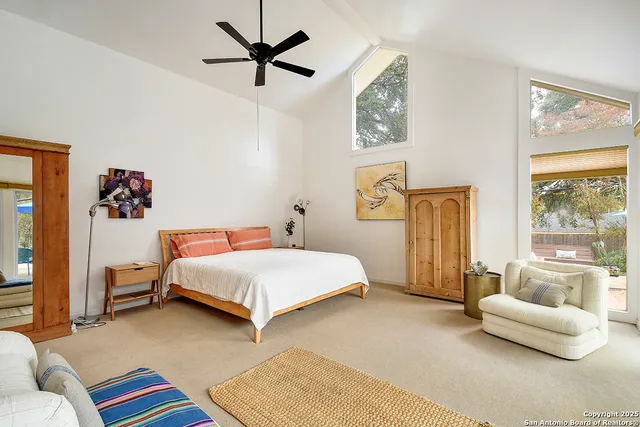 a bedroom with a bed couch and window