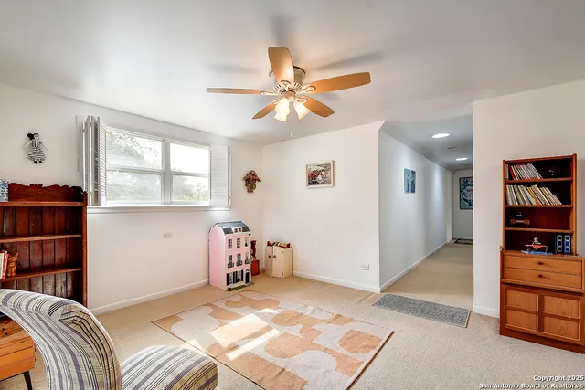 a bedroom with furniture and a book shelf