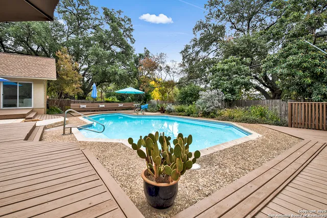 a view of a swimming pool with a patio and a patio