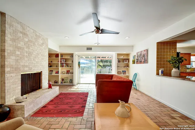 a living room with furniture fireplace and flat screen tv