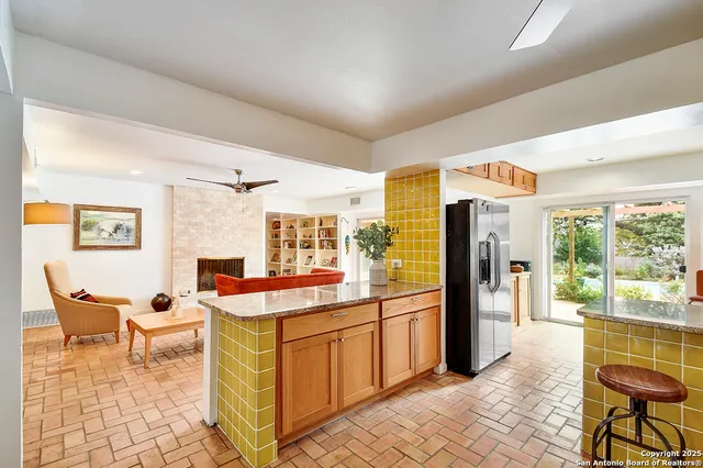 a very nice looking living room with a large window and stainless steel appliances